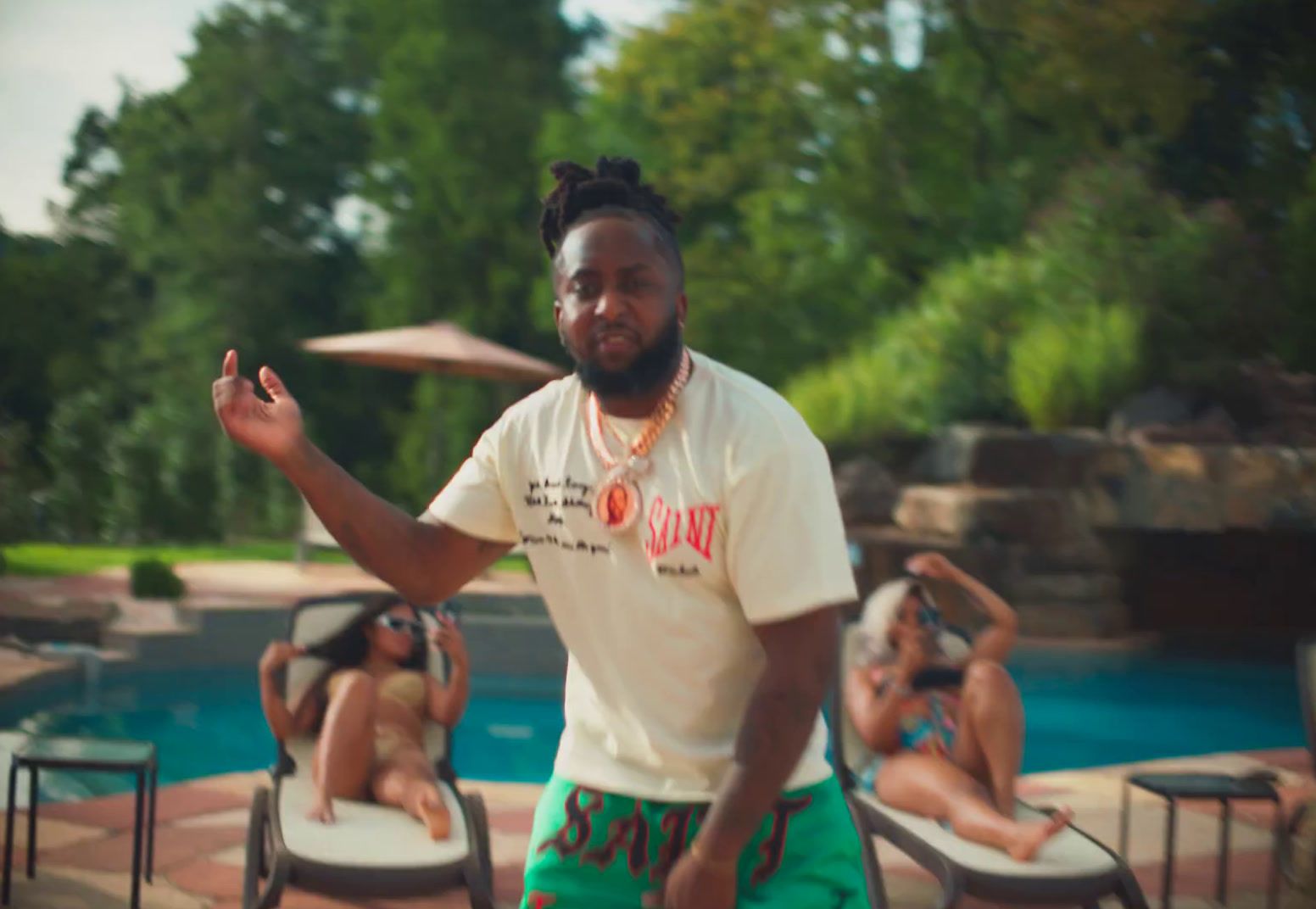 a man standing in front of a pool holding a frisbee