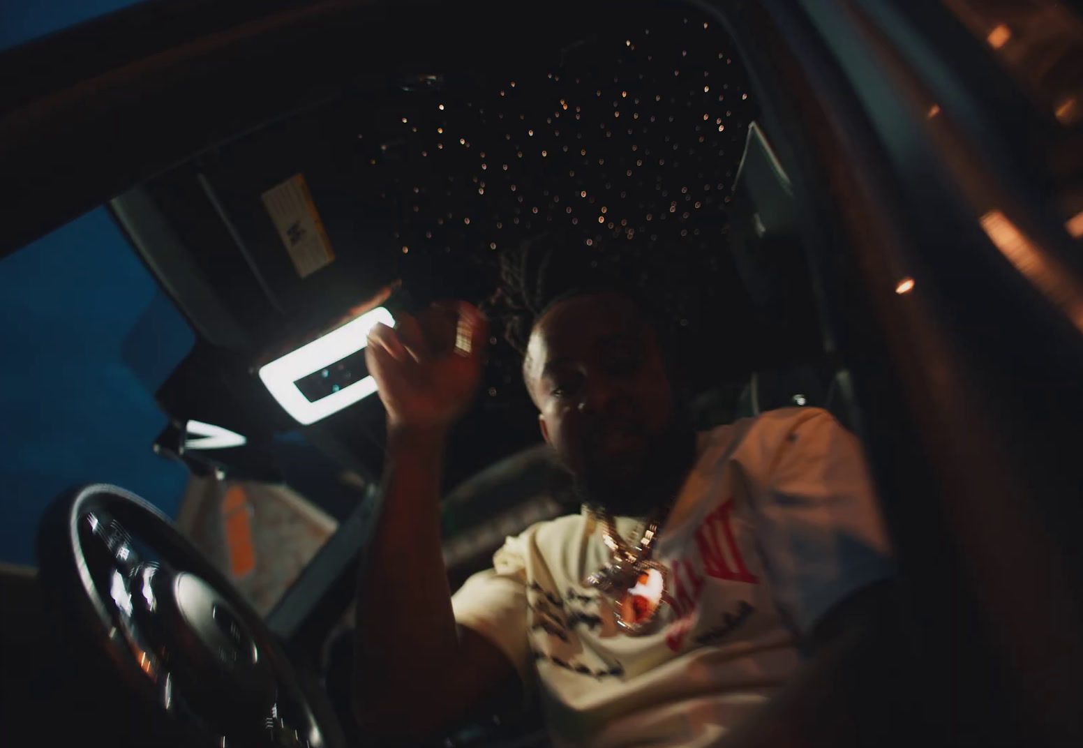 a man sitting in a car holding a cell phone