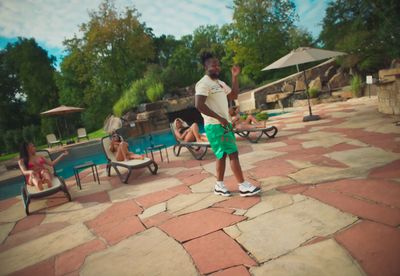 a man standing in front of a swimming pool