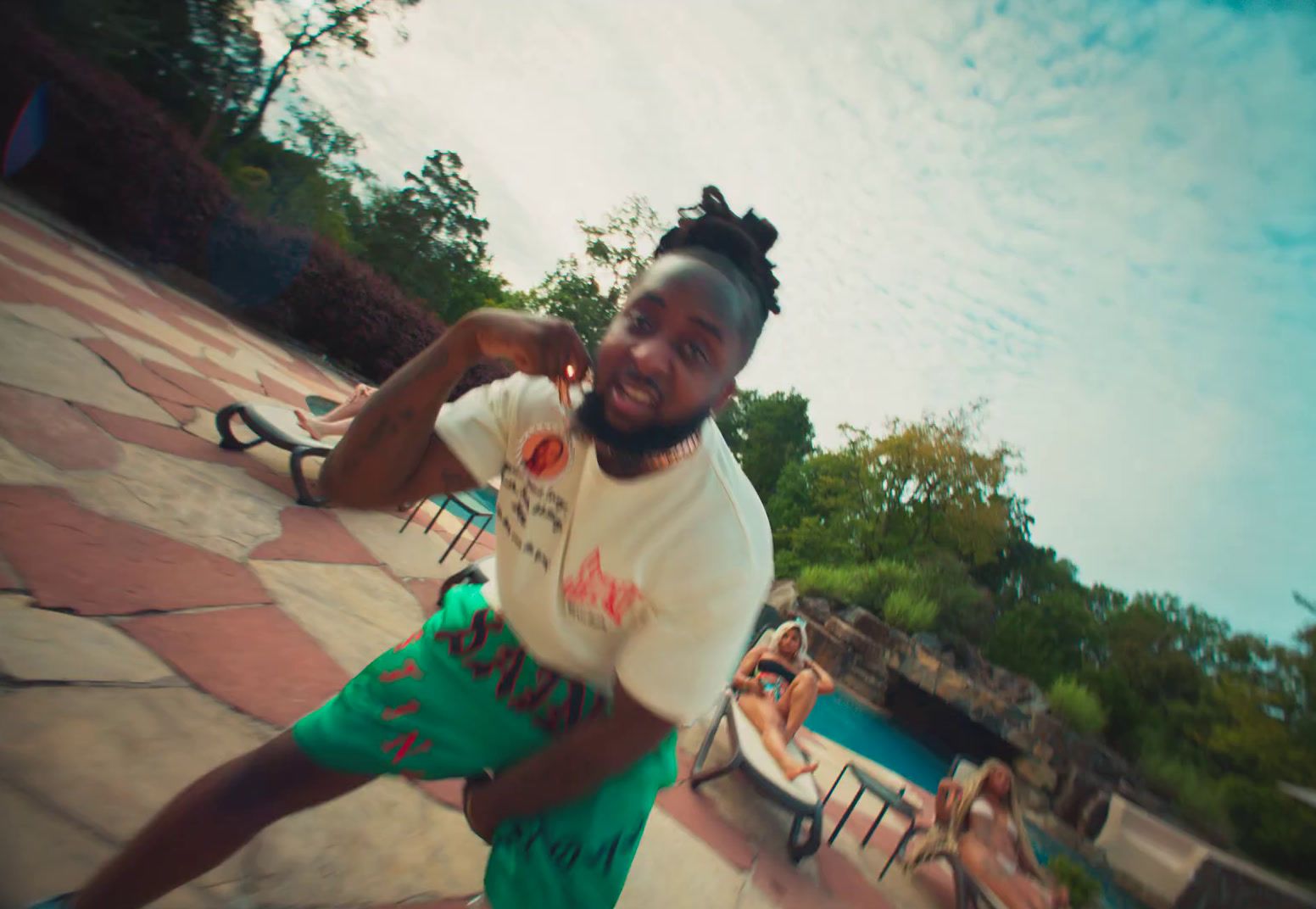 a man with dreadlocks is dancing in a pool