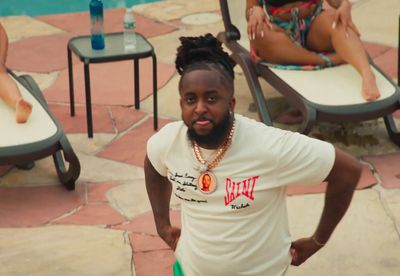 a man standing in front of a swimming pool