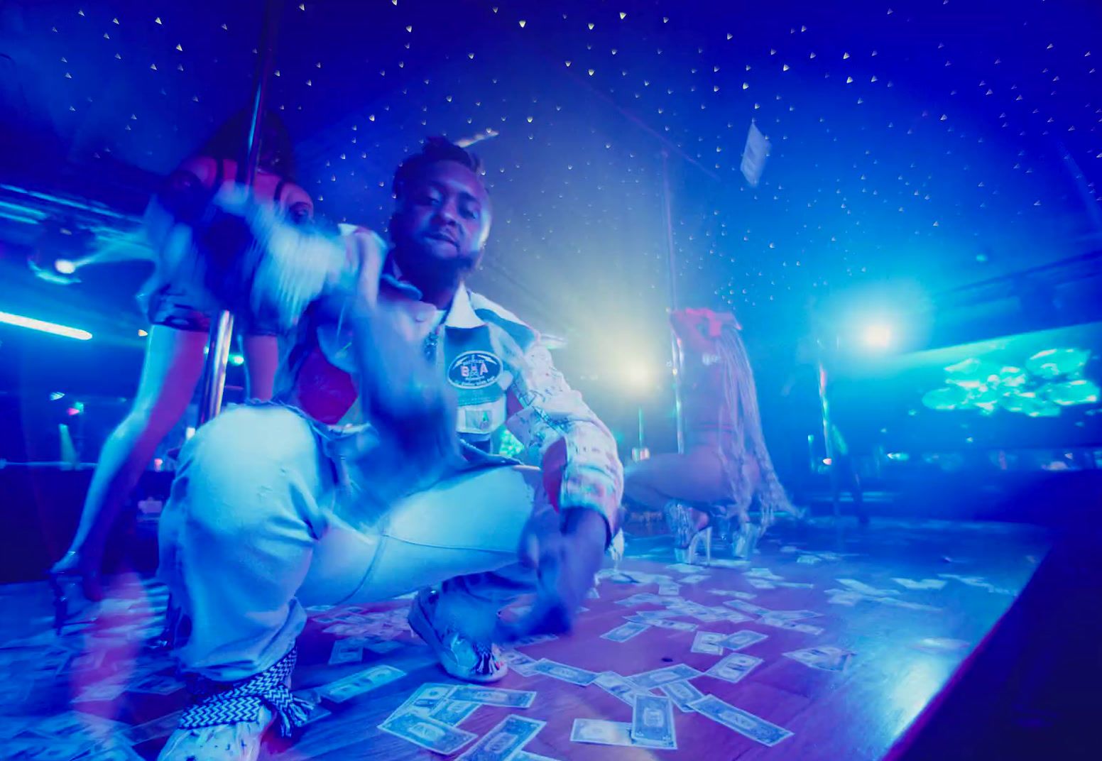 a man sitting on top of a wooden floor