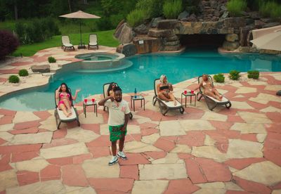 a group of people sitting around a pool