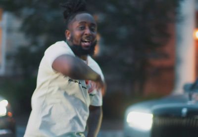 a man is throwing a frisbee in the street