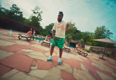 a man in green shorts is playing frisbee