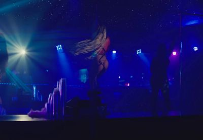 a woman standing on a stage in front of a crowd