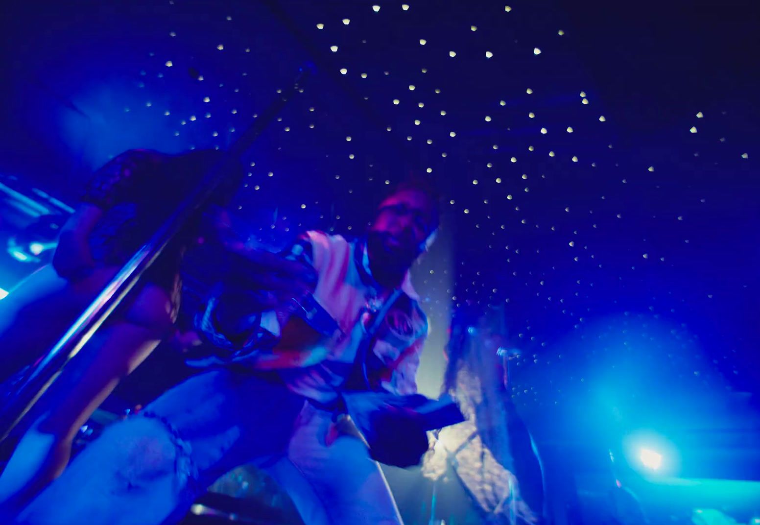 a man standing on a stage in front of blue lights