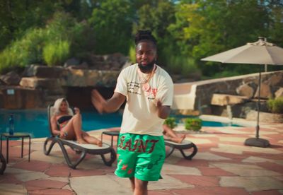 a man standing in front of a swimming pool