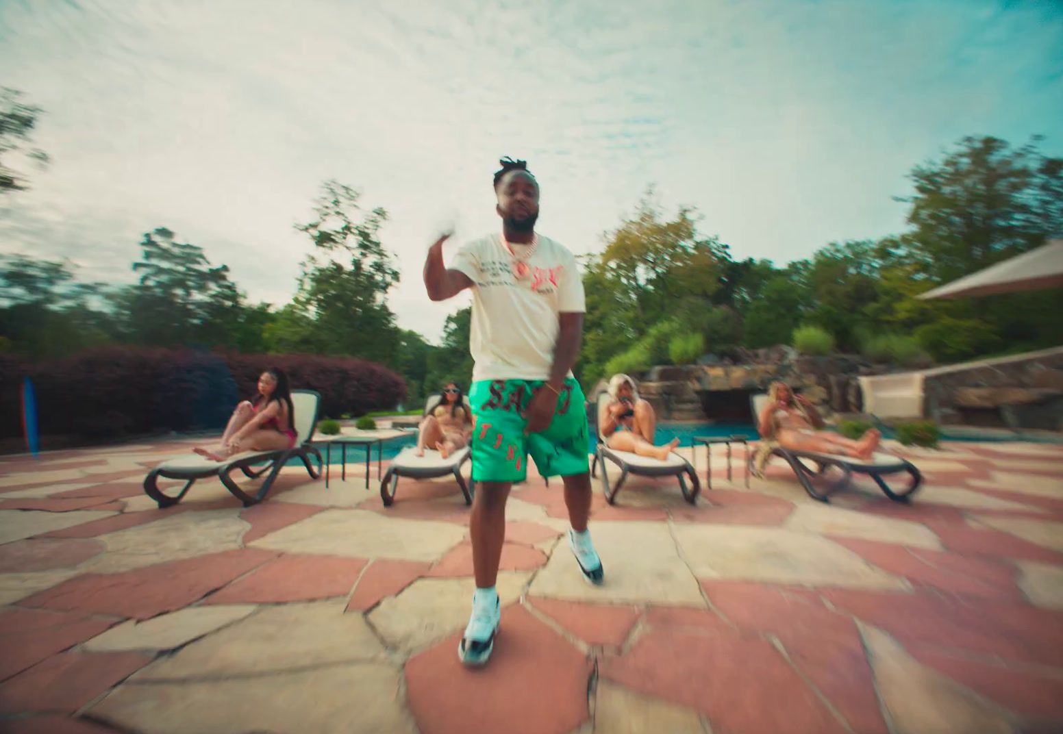 a man standing in front of a pool with a frisbee in his hand