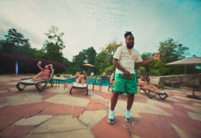 a man standing in front of a swimming pool