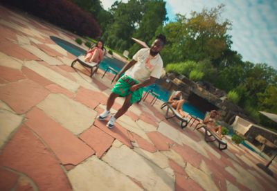 a man in a white shirt is playing with a frisbee