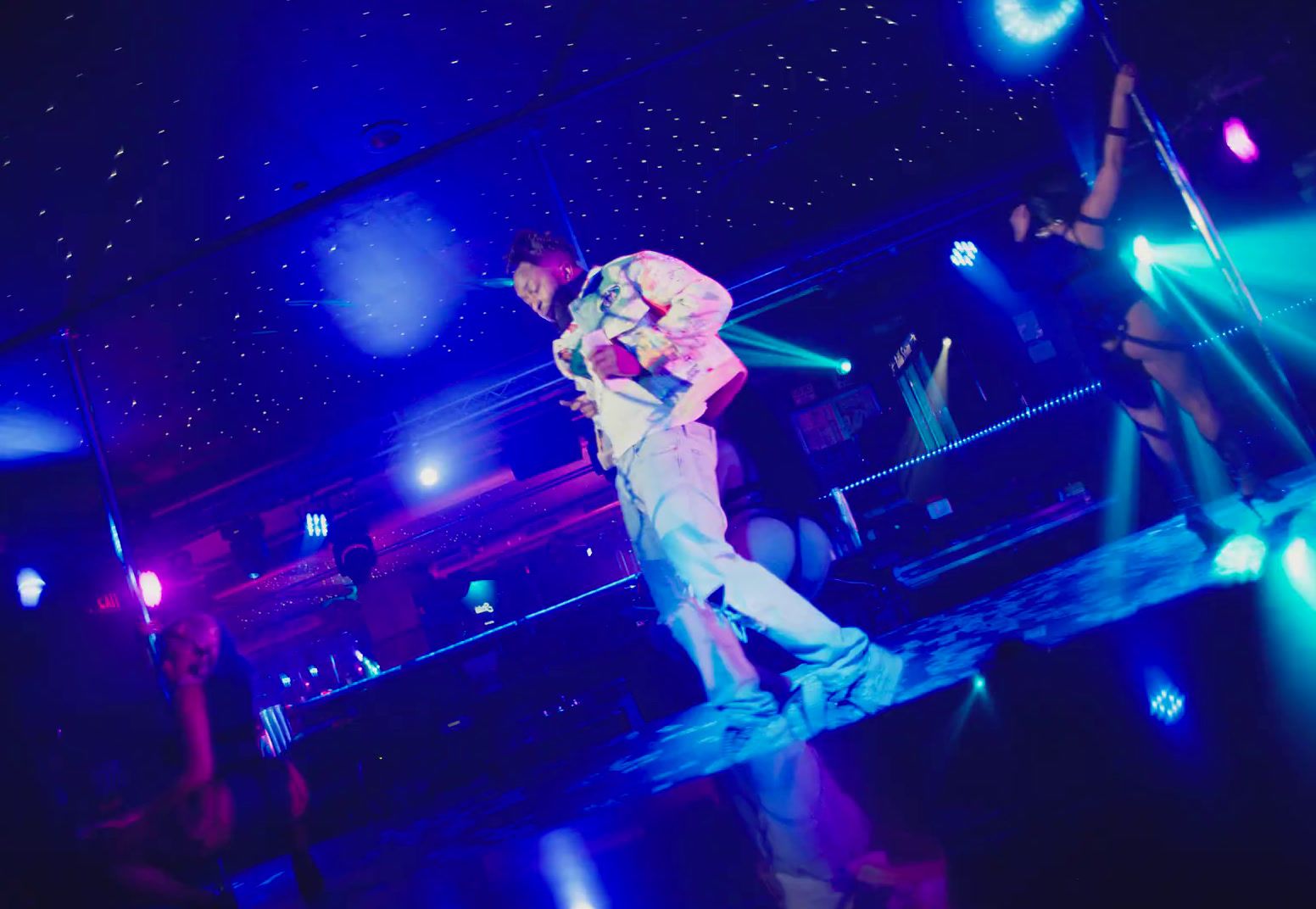 a man standing on a stage in front of a crowd