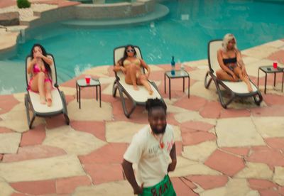 a man standing in front of a swimming pool