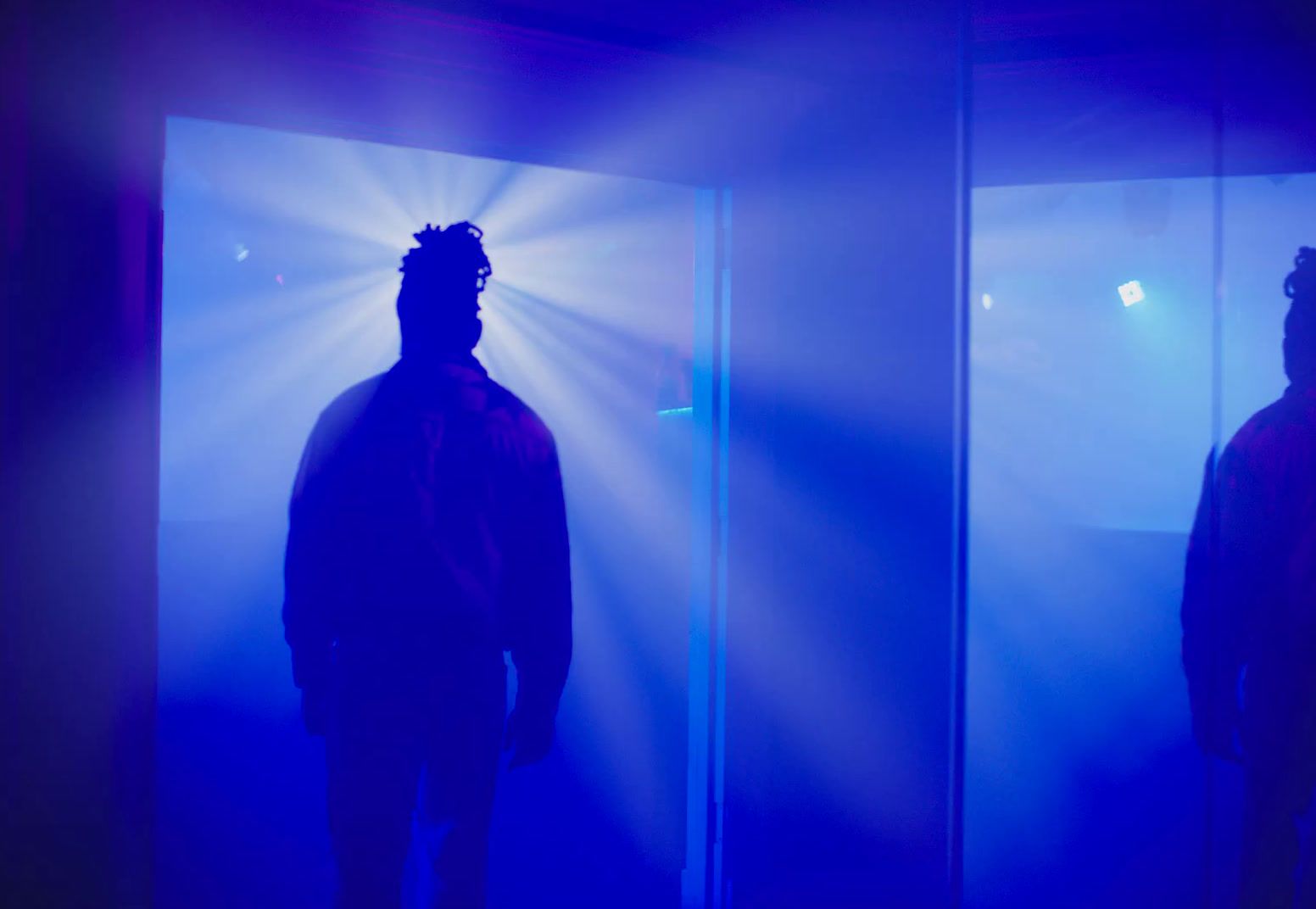 a man standing in front of a mirror in a room