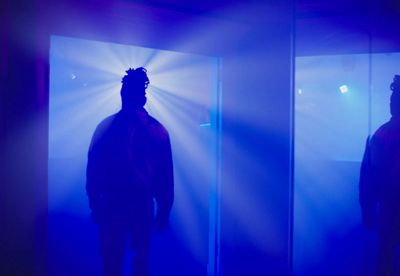 a man standing in front of a mirror in a room