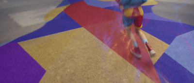 a person riding a skateboard on a colorful floor