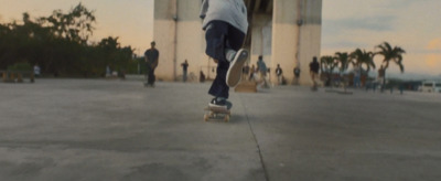 a man riding a skateboard down a sidewalk