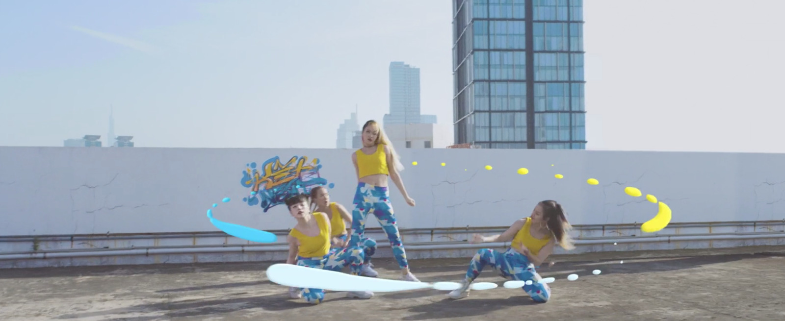 a group of young women standing on top of a roof