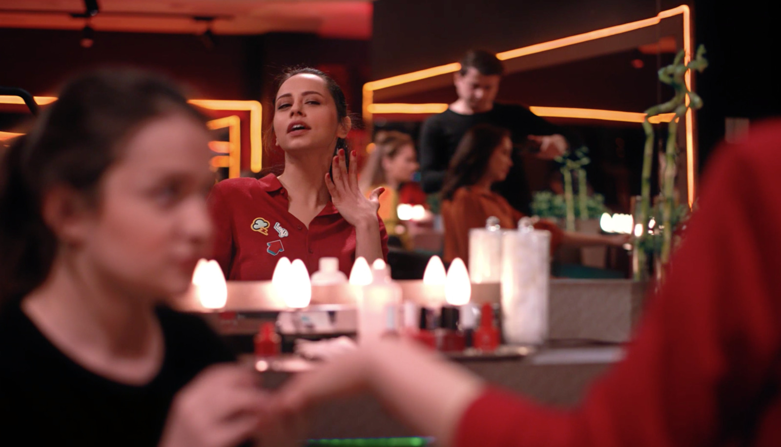 a woman standing in front of a counter with candles