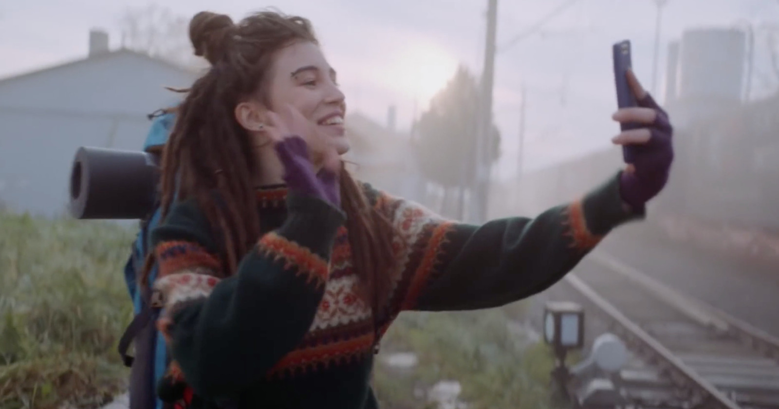 a woman with dreadlocks holding a cell phone