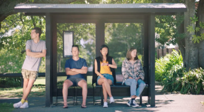 a group of people sitting on a bench in a park