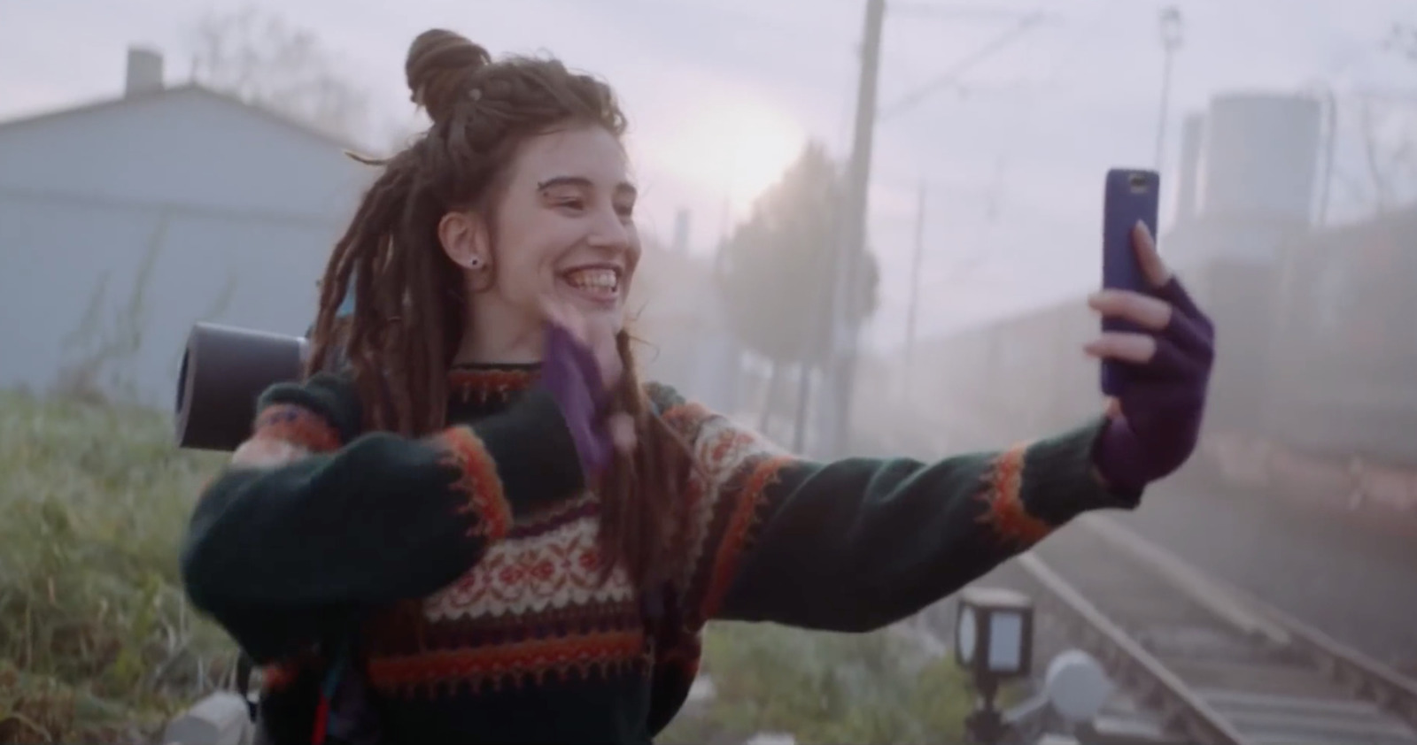 a woman with dreadlocks taking a selfie