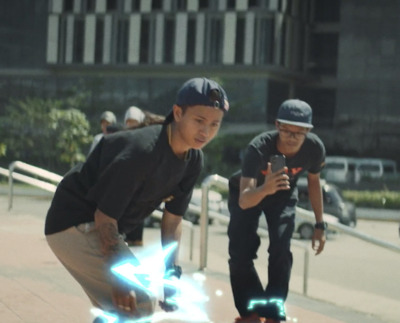 a couple of young men riding skateboards down a sidewalk