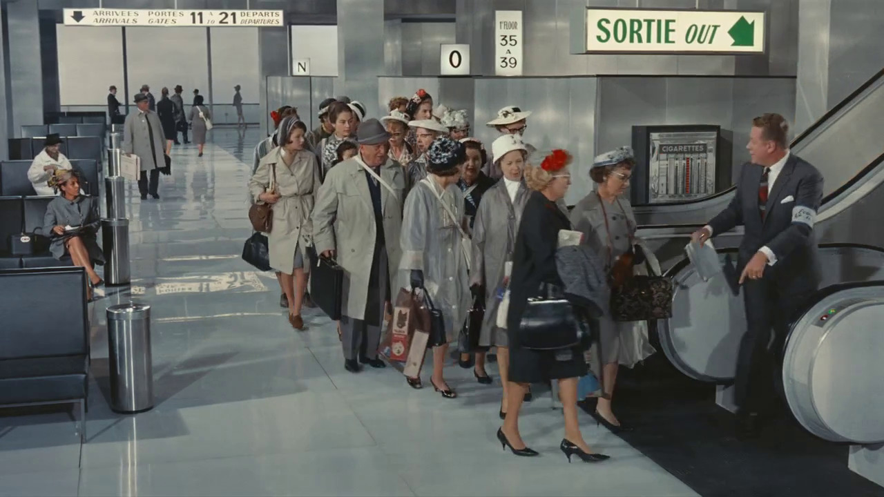 a group of people walking through an airport