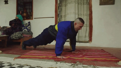 a man is doing a handstand on a rug