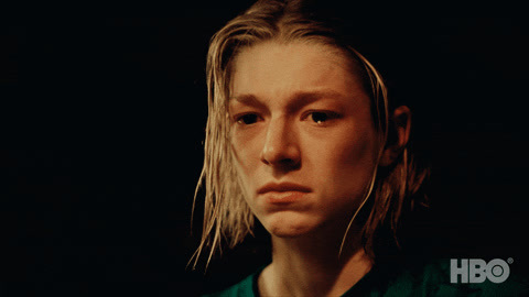 a woman with blonde hair and a green shirt