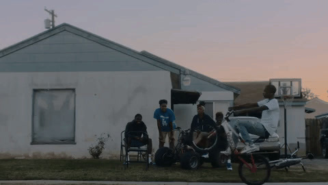 a group of people standing in front of a house