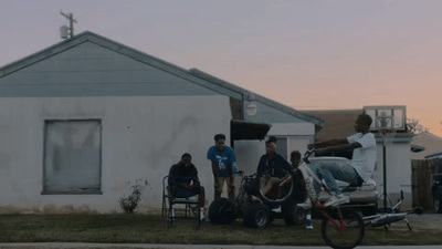 a group of people standing in front of a house