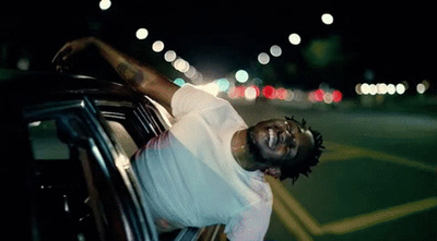 a man leaning out of a car window at night