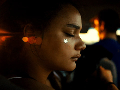 a woman with a white star on her nose