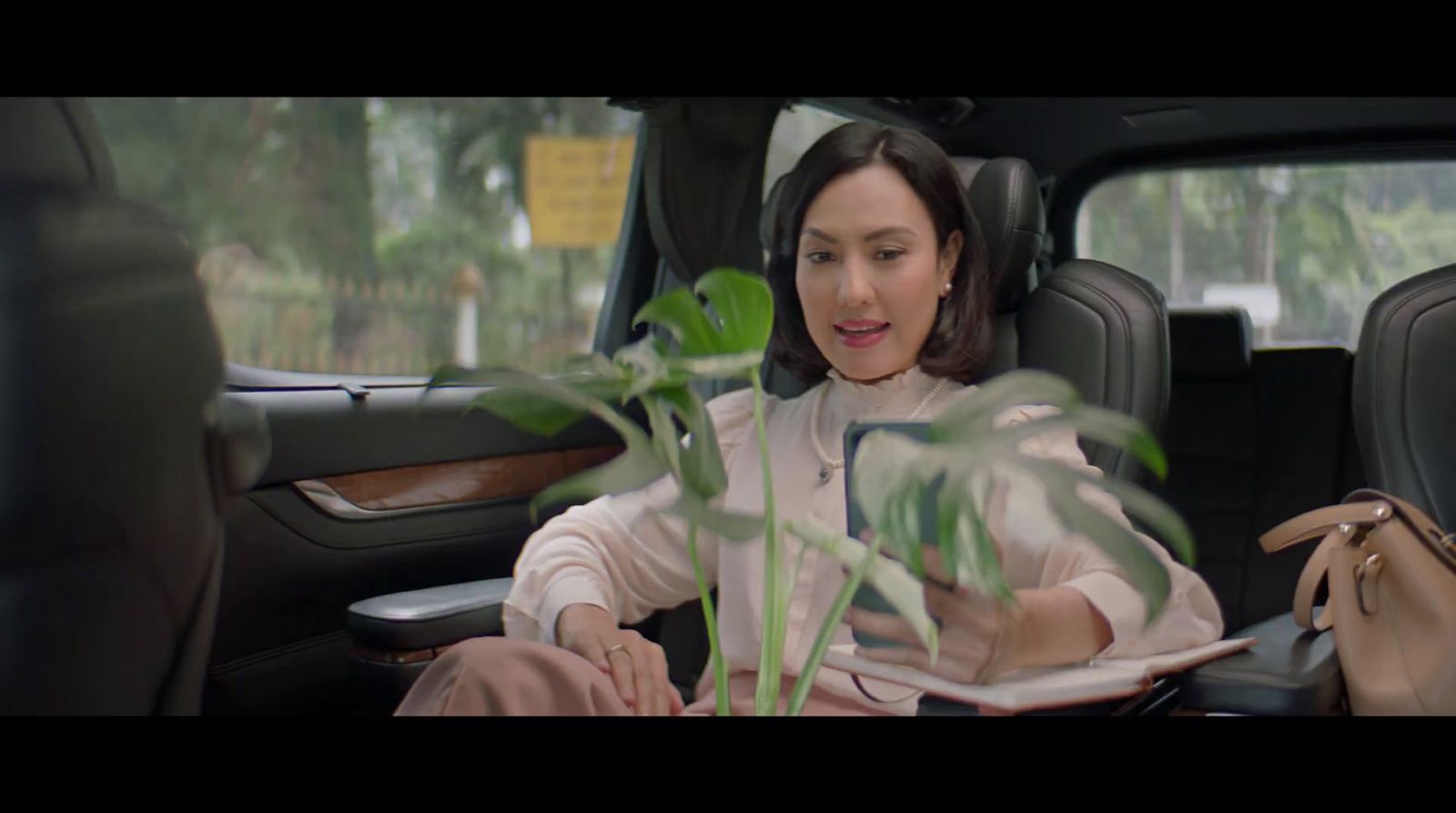 a woman sitting in the back seat of a car