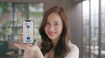 a woman holding up a cell phone in her hand