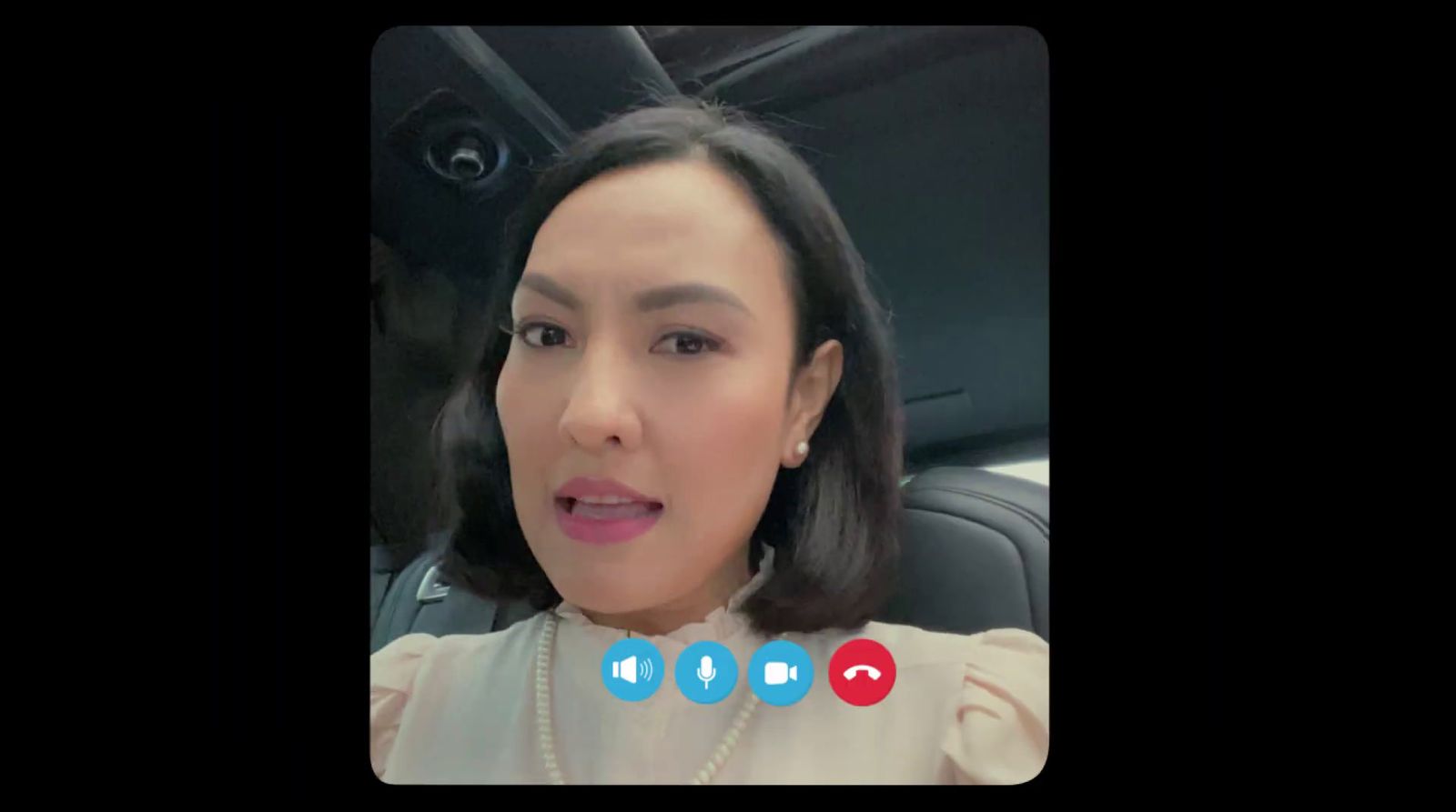 a woman in a car talking on a video call