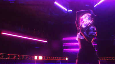 a man standing in front of a purple light