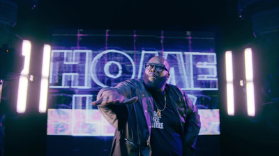 a man standing in front of a neon sign