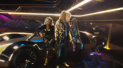 a group of women standing next to a futuristic car