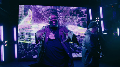 a man standing in front of a large screen