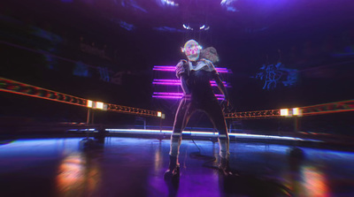 a woman in a black outfit standing on a stage