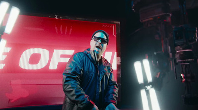 a man standing in front of a red sign