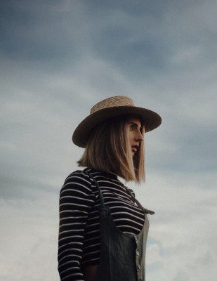 a woman wearing a hat and a striped shirt