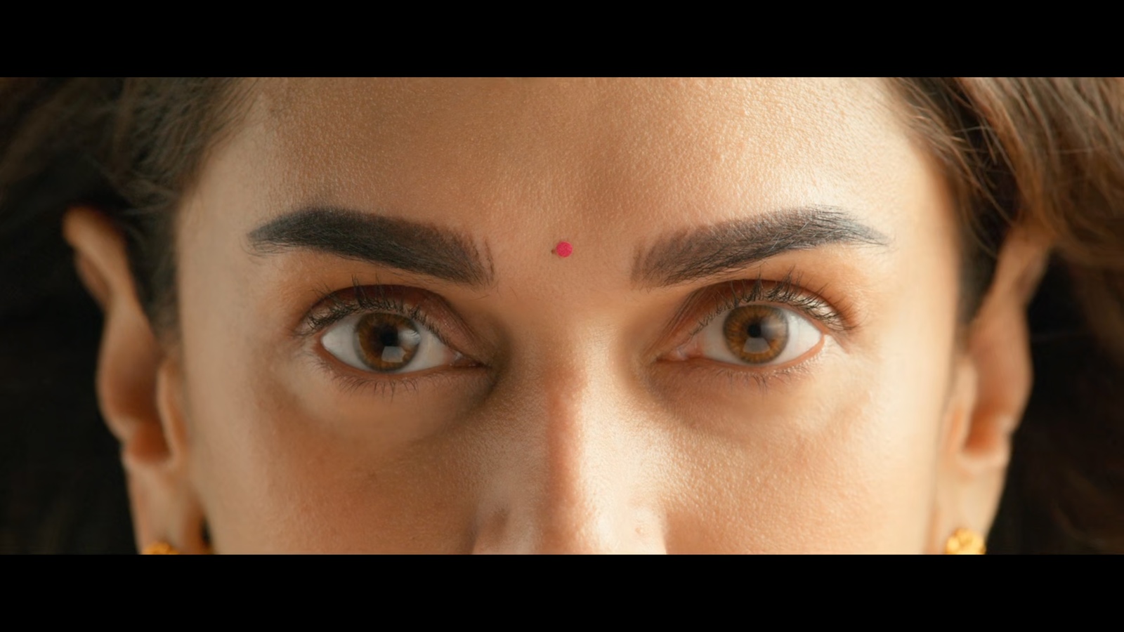 a close up of a woman's face with brown eyes