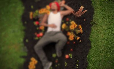 a man laying on the ground in the grass