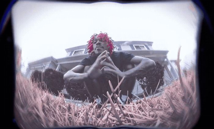 a man sitting in a field of tall grass