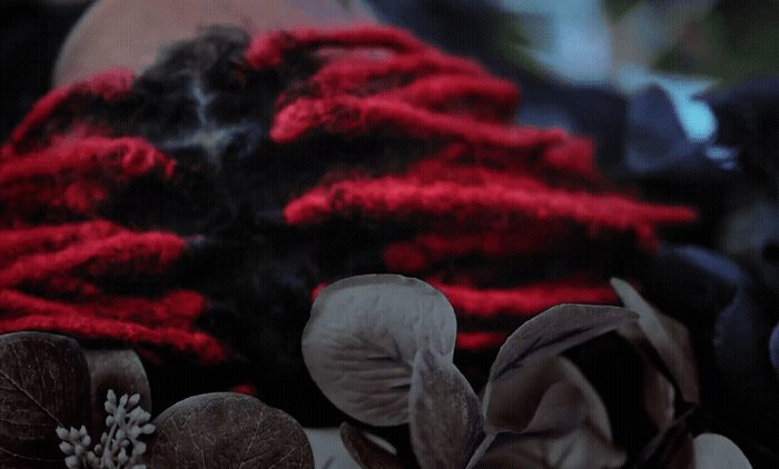 a red and black scarf with flowers on it