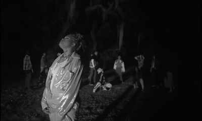 a group of people standing around in the dark