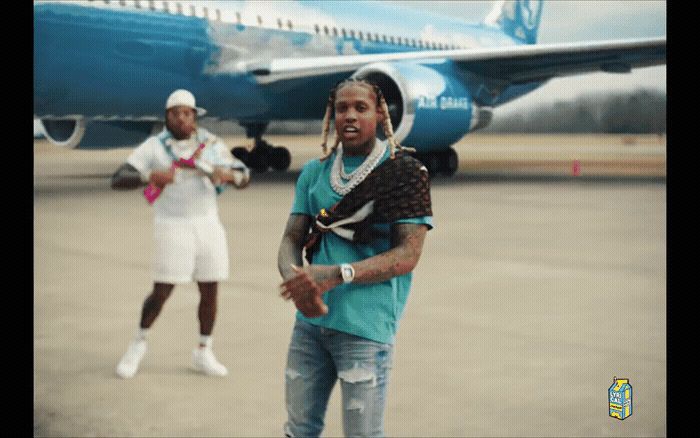 a couple of men standing next to an airplane